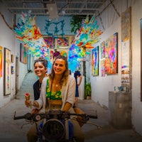 two women sitting on a motorcycle