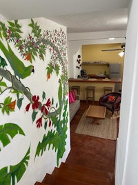 a living room with a mural painted on the wall