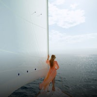 a woman in an orange dress standing on the bow of a sailboat