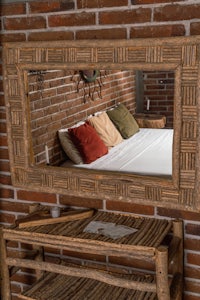 a bed with a mirror and a bedside table