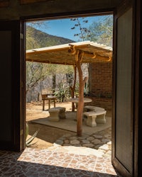 a doorway to a patio with a table and chairs